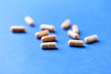 Lutein capsules. Dietary supplement on bright background. Soft focus. Close up. Copy space