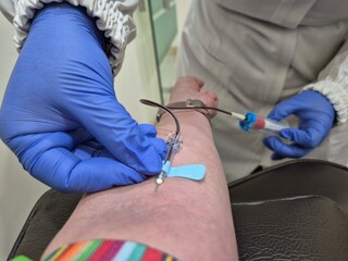 Nurse taking blood sample to make a test in laboratory. Photo was taken close up.