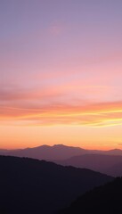 the sky at sunset with mountains in the background