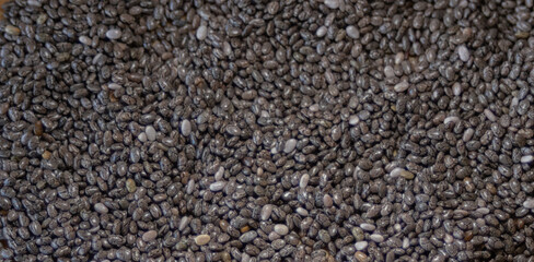 Chia seeds scattered for product background. Top view.