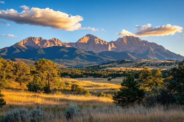 Obraz premium Mountain Range Under Blue Sky and Golden Fields