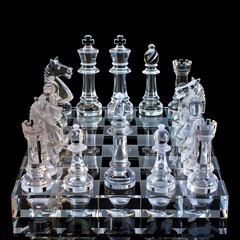 A chess set made of clear glass pieces