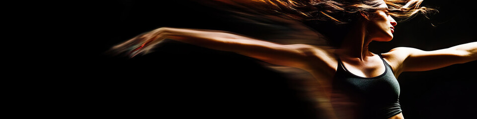 Obraz premium A woman in a dance class, moving gracefully through the air as if weightless.