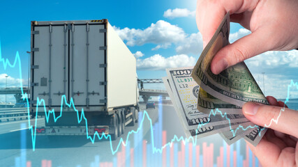 Logistics budget. Truck is driving along road. Money in hands of man. Delivery budget fluctuation...