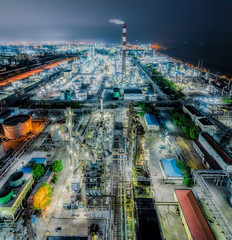 Refinery chemical plant industrial equipment in large industrial area at night. Business Finance and Industry