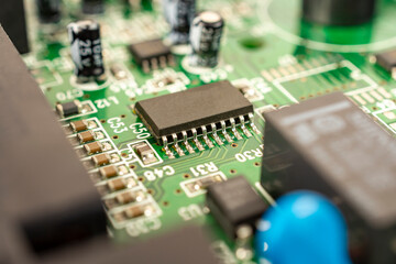 Fototapeta premium Close-up of a circuit board with microcircuits from an electrical appliance or computer. Selective focus.