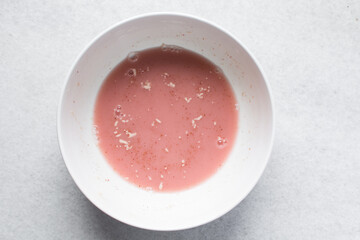 Instant dry yeast sprinkled on warm water, dry yeast granules on water