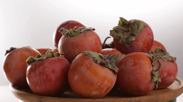 harvest of ripe persimmon on plate chocolate kinglet rotation food