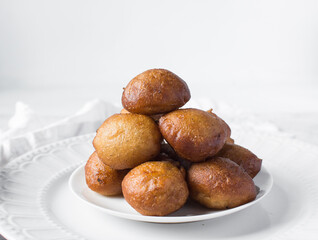 nigerian puff-puff on a white plate, nigerian fried dough balls, flatlay of homemade bofrot on...