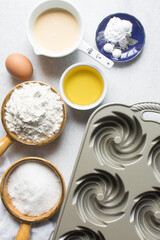 Overhead view of mise en place of ingredients for making a vanilla cake, process of making cake