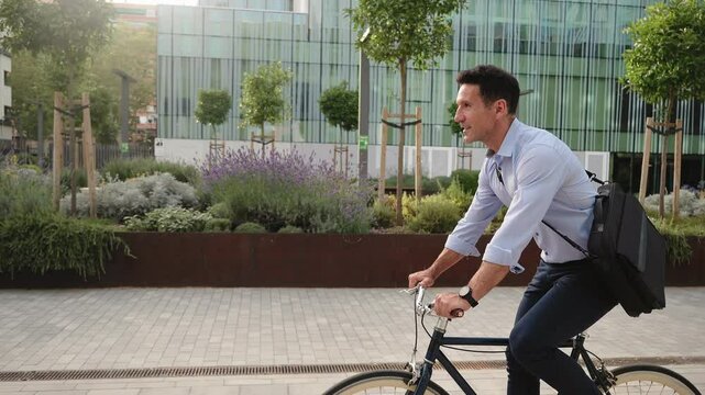 Businessman commuting to work by bicycle in the morning
