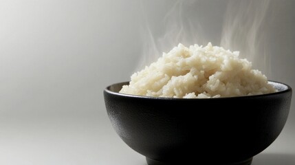 Bowl of freshly cooked white rice with steam rising, perfect side dish or main course