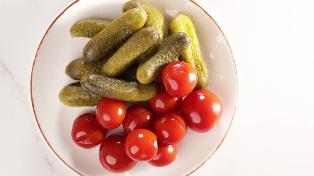pickled cherry tomatoes cucumber food  top view on light surface