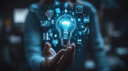 Hand holding an illuminated light bulb with digital icons, Business idea light bulb with technology icon