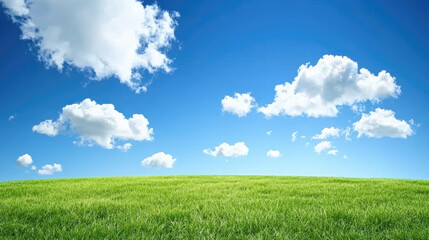 Obraz premium vibrant green field under bright blue sky with fluffy white clouds creates serene and peaceful landscape