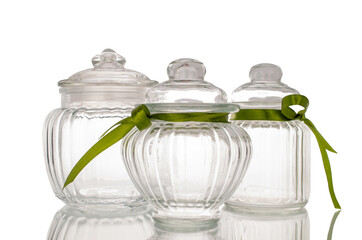 Three glass jars, macro, isolated on white background.