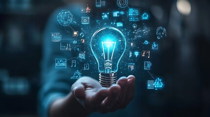 Hand holding an illuminated light bulb with digital icons, Business idea light bulb with technology icon