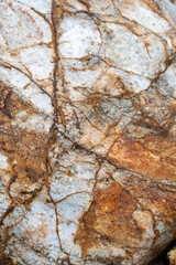 Close up of ancient rocks on Red Island containing minerals and metals