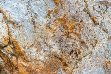 Close up of ancient rocks on Red Island containing minerals and metals
