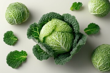 savoy cabbage heads with crinkled leaves on light green background.