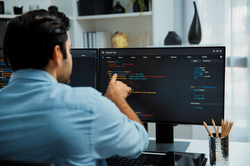 Concentrating in smart IT developer working software development coding on two pc screen, creating...