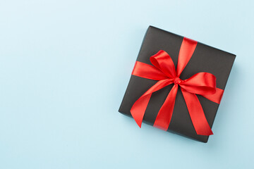 Black gift boxes on color background, top view. Black Friday concept