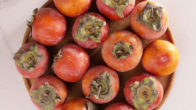 top view of harvest of persimmon fruits on plate food