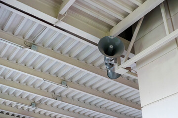 Public address system hanging from metal ceiling structure