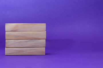 Stacking 3 rectangle empty wooden blocks on table with light purple background for own customer text or letters. Idea of environment, energy or business concept. Front view, banner copy space.