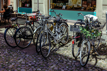 Bicycle parking on a narrow cobblestone street in the medieval city of Modena