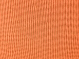 Fototapeta premium Orange textured knitted fabric background, knit