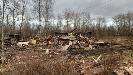 Ruins of a Collapsed Wooden House with Construction Debris and Wreckage, Post-Demolition Scene