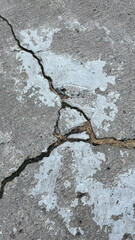 Close-up of Cracked Concrete Road with Large Fracture, Urban Infrastructure Texture, Top View