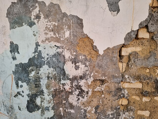 The gray white walls with white bricks were cracked and corroded like an abstract art painting