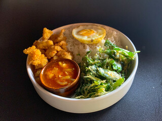 Fried chicken dish, crispy spinach, fried egg, combined with Singapore sauce. rice bowl, breakfast, healthy food