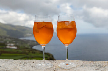 Two glasses of Aperol Spritz agaist the ocean view