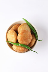 Kachori, green chilly, kachori is a spicy snack from India also called  kachauri and kachodi. Favorite Tea time snacks
served in a ceramic bowl