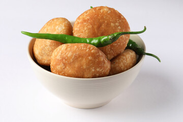 Kachori, green chilly, kachori is a spicy snack from India also called  kachauri and kachodi. Favorite Tea time snacks
served in a ceramic bowl