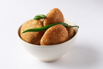Kachori, green chilly, kachori is a spicy snack from India also called  kachauri and kachodi. Favorite Tea time snacks
served in a ceramic bowl