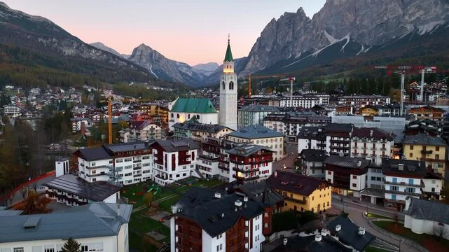 Drone view of Cortina d Ampezzo village in the Dolomites in Italy at sunrise, beautiful famous Italian alpine town of Cortina, Winter Olympics site, travel in the Dolomites