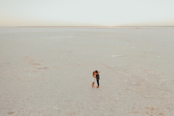 pink Lemurian lake, romantic photoshoot of young couple in love