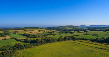 Fototapeta premium Aerial View of Rolling Hills & Green Fields in Irish Countryside