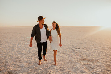 pink Lemurian lake, romantic photoshoot of young couple in love