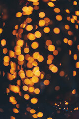 abstract background with bokeh defocused lights and shadow from christmas night party. Beautiful bokeh abstract texture blurred light orange background.