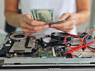 Obraz premium Technician repairs internal computer laptop and price cost of repair laptops video cards. Integrated circuit. concept of data, equipment