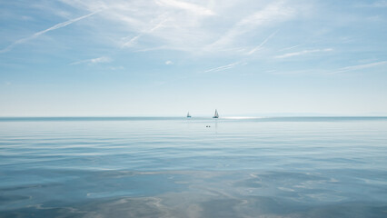 Beautiful sunny autumn view of the lake Balaton with two sailboats.