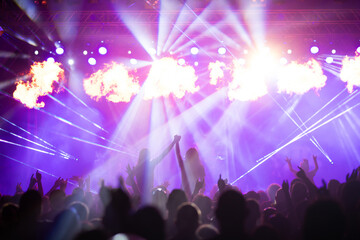 Crowd at concert and colorful stage lights.