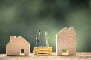 Two businessmen standing on the stack coins are negotiating for buy and sell or exchange purchase a...