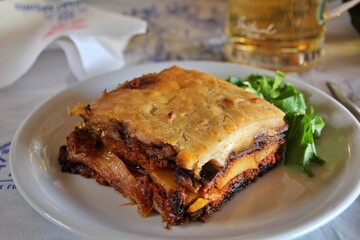 typical Greek dish, moussaka, layered eggplants, a large piece of moussaka
