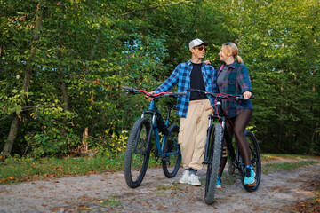 Obraz premium Happy man and girl in nature during a bike ride